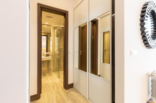 a hallway with glass doors in a bathroom at Belgrade Center Apartment Lux in Belgrade