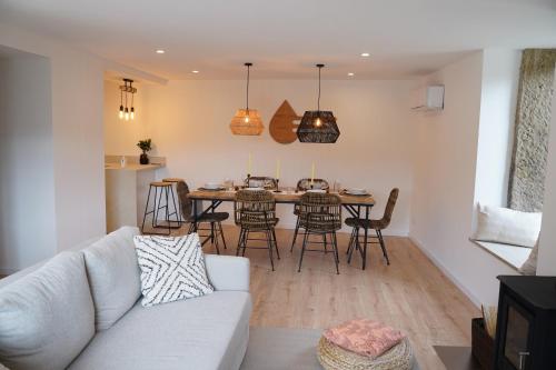 a living room with a couch and a table at Quinta da Enxurreira in Ponte de Lima