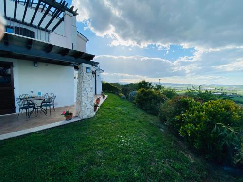 a house with a table and chairs on a lawn at CASA VACANZA FELICITA' in Porto Potenza Picena