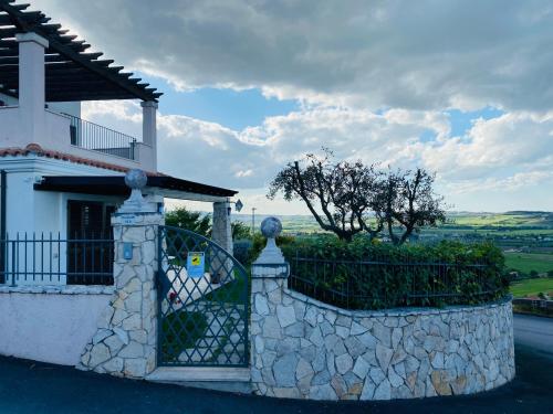 a stone fence in front of a house at CASA VACANZA FELICITA' in Porto Potenza Picena