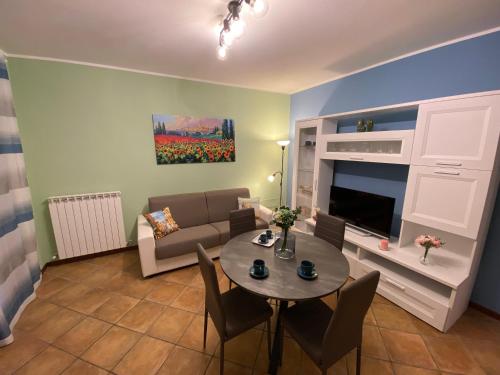 a living room with a table and a couch at CASA VACANZA FELICITA' in Porto Potenza Picena