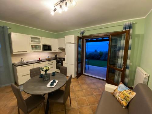 a kitchen and dining room with a table and chairs at CASA VACANZA FELICITA' in Porto Potenza Picena