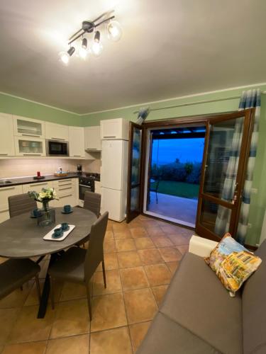 a kitchen and living room with a table and chairs at CASA VACANZA FELICITA' in Porto Potenza Picena