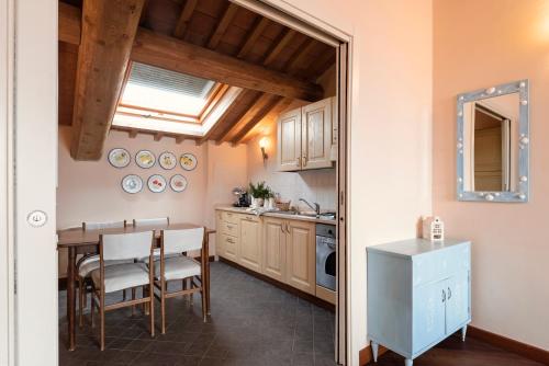 a kitchen with a table and a dining room at Residenza Santa Cecilia in San Vincenzo