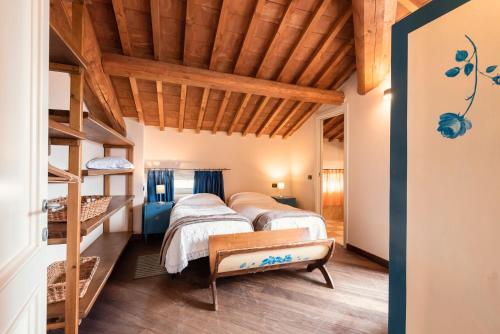 two beds in a room with wooden ceilings at Residenza Santa Cecilia in San Vincenzo