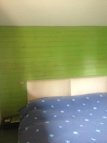 a bed with a blue blanket with stars on it at Residenza Il Porto in Padenghe sul Garda