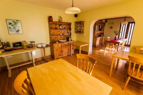 a kitchen and dining room with a table and chairs at Sunville Bed And Breakfast in Ballycotton