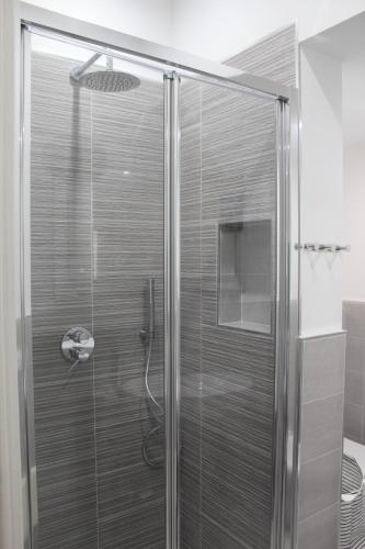 a shower with a glass door in a bathroom at Maresole Cefalù in Cefalù