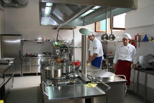 two chefs standing in a kitchen preparing food at Lazensky Hotel Park in Poděbrady