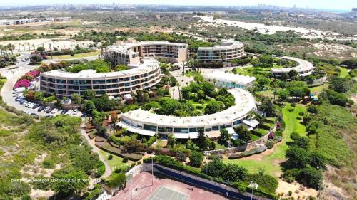 an aerial view of a large building with a park at neot golf kz place in Caesarea