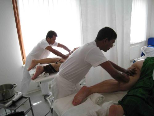 two men in a hospital room with a patient on a bed at Lazensky Hotel Park in Poděbrady