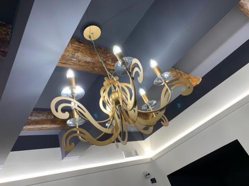 a chandelier hanging from a ceiling in a room at Toledo Boutique Rooms in Naples