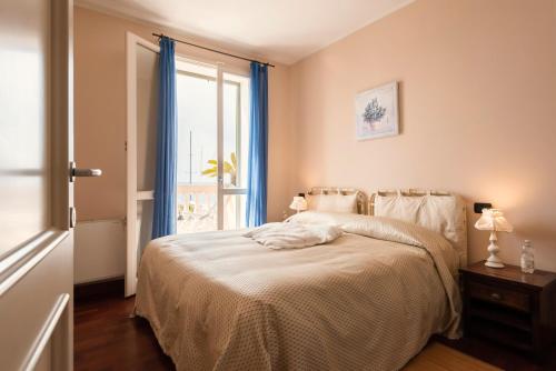 a bedroom with a bed and a window at Residenza Santa Cecilia in San Vincenzo