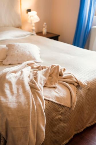 a close up of a bed with a blanket on it at Residenza Santa Cecilia in San Vincenzo