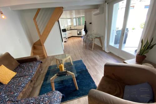 a living room with a couch and a table at Tiny House - town house in the centre of Annecy terrace & air conditioning in Annecy