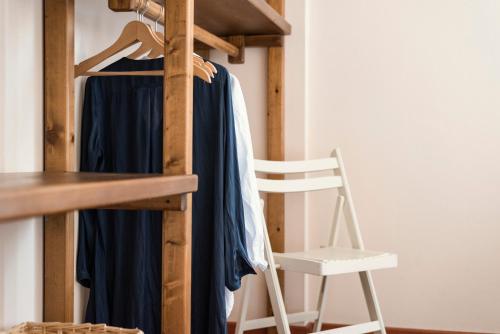 a room with a bunk bed and a white chair at Residenza Santa Cecilia in San Vincenzo