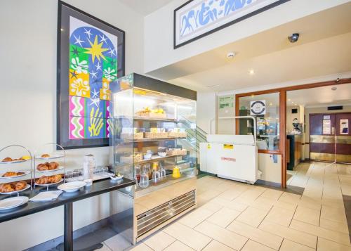a bakery with a display case filled with food at Staindrop Hotel in Sheffield