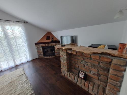 a brick fireplace in a room with a brick oven at San na vodi in Smederevo