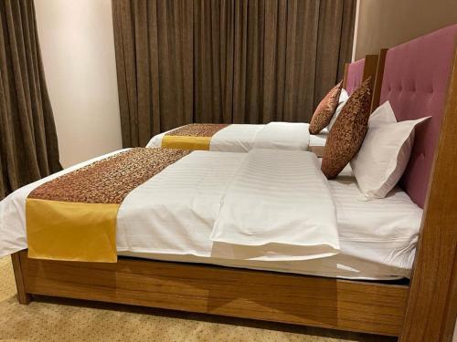 Postel nebo postele na pokoji v ubytování Hosta Serviced Apartments - Al Yasmin