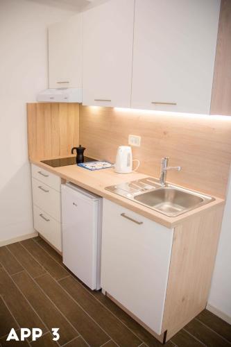 a small kitchen with a sink and a counter at Casa Maly in Portorož
