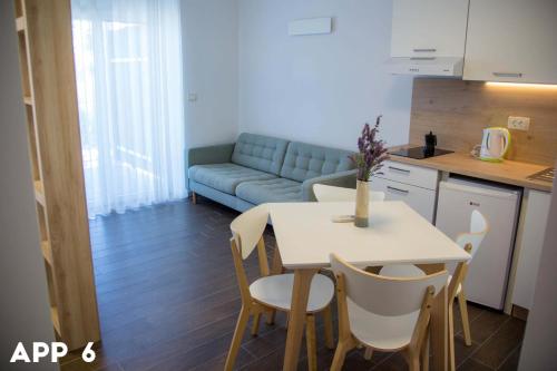 a living room with a table and a couch at Casa Maly in Portorož