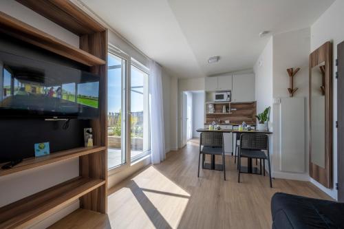a kitchen and living room with a large window at ATHOME RESIDENCE ET SPA in La Rochelle