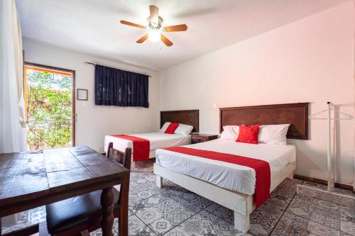 Cama o camas de una habitación en Hotel Posada Bugambilias