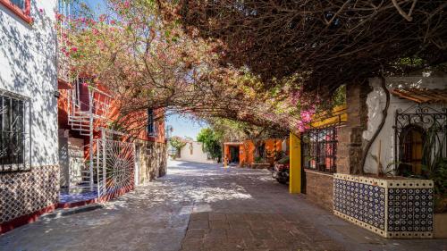 an alley in an old town with an archway at Hotel Posada Bugambilias in San Luis Potosí