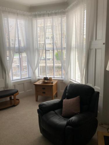 a living room with a couch and a large window at Milton Lodge in Weston-super-Mare