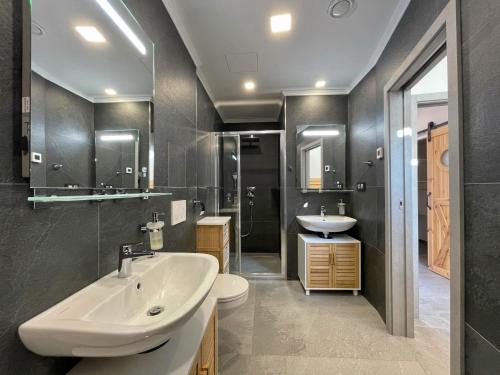 a bathroom with a white sink and a toilet at Magic Apartment centre mezonet in Pilsen