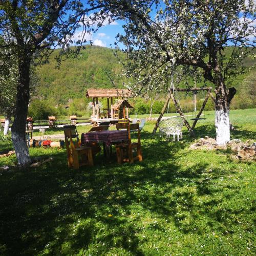 a picnic table in the shade of a tree at Etno Konak Angela in Kalna