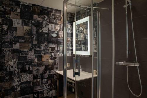 a bathroom with a shower and a sink and a mirror at Hôtel et Spa La Villa K - Basel Airport in Saint-Louis