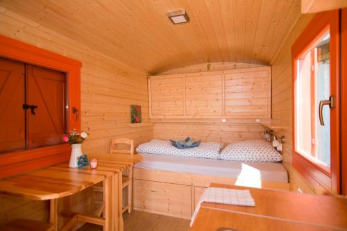 Habitación con cama en una cabaña de madera en Schäferwagen 2, en Kröpelin