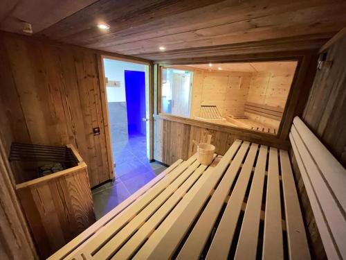 a wooden sauna with a bench in the middle at Hotel Restaurant Rosengarten in Zell am Ziller