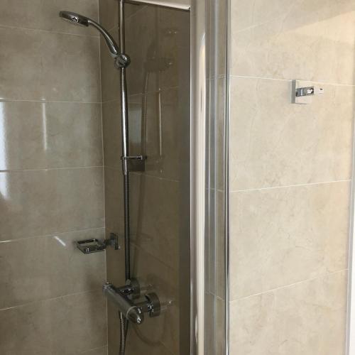 a shower with a glass door in a bathroom at Petra House B&B in Galway
