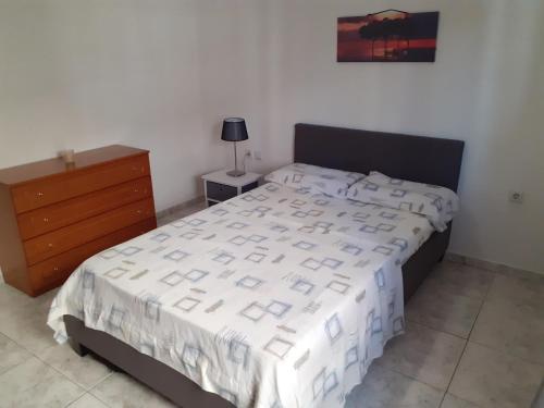a bedroom with a large bed and a dresser and a bed sidx sidx sidx at Asteris appartment in Thérmi