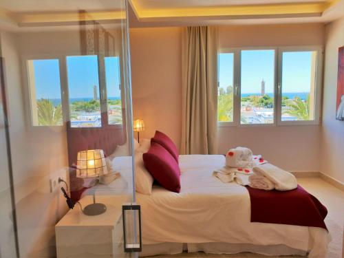 a hotel room with a bed with a view of the ocean at FANTASTIC APARTMENT B IN FRONT OF THE SEA & MARINA in Estepona