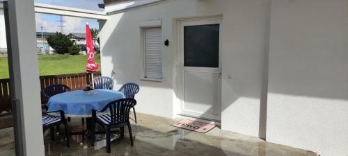 a patio with a table and chairs and a television at FEWO Außerlechner in Innsbruck