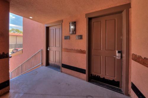 an empty hallway with two doors and a balcony at The Gonzo Inn in Moab