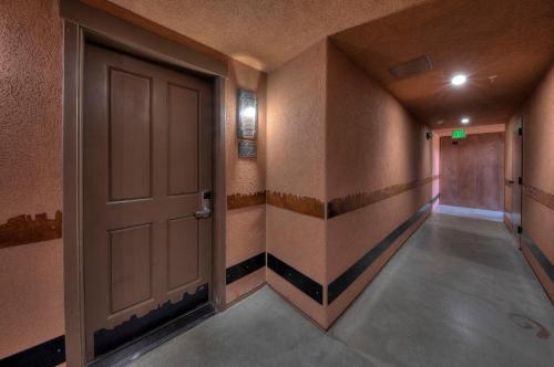 an empty hallway with a door in a room at The Gonzo Inn in Moab