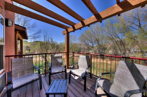 a deck with three chairs and a table at The Gonzo Inn in Moab