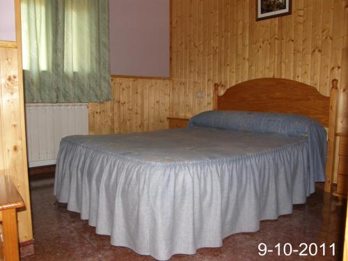 a bedroom with a bed in a wooden room at Apartamento EL BALCON in Cuenca