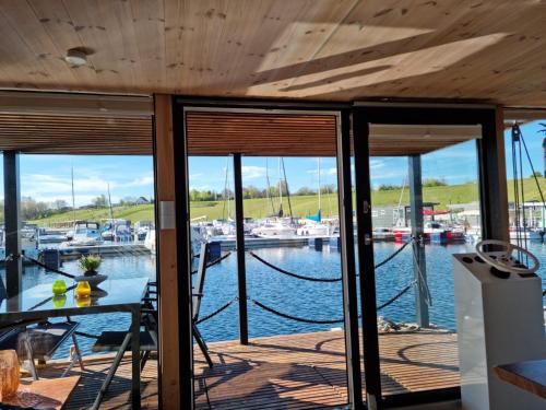 a porch with a view of a marina at Hausboot Geiselruh in Braunsbedra