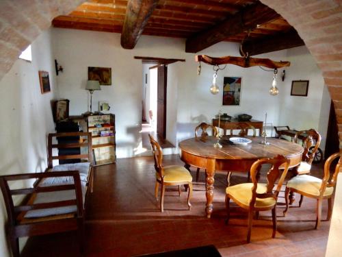 a dining room with a wooden table and chairs at Palazzo Di Bagnaia in Castel del Piano