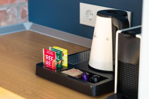 a tray with a coffee maker next to a coffee pot at Lavender Inn Guest House in Viešvėnai