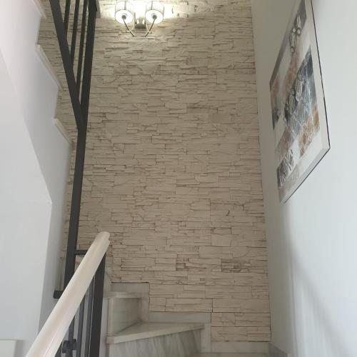 a staircase with a brick wall and a light fixture at Niza Beach in Málaga