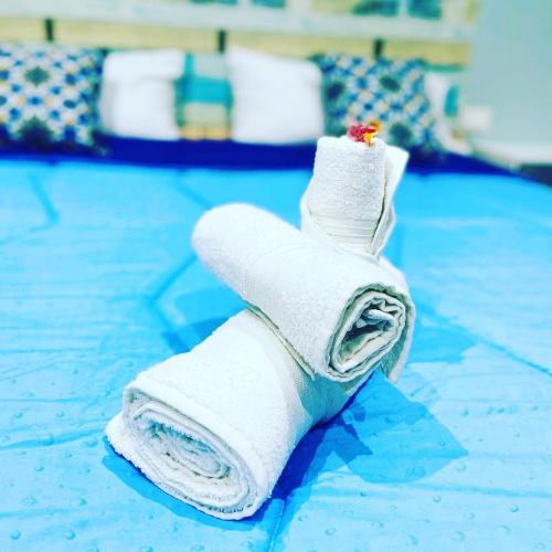 a rolled up towel on the floor of a pool at La Piccola Formica Charme Rooms in Palermo