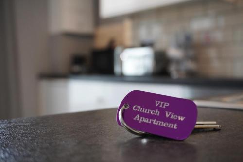a purple cup sitting on top of a counter at VIP Church View Apartment in Portadown