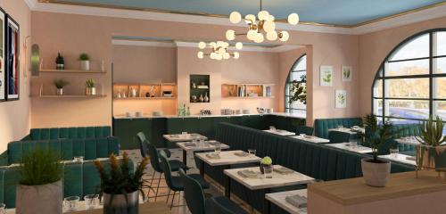 a restaurant with tables and chairs in a room at Grand Hôtel Saint-Aignan in Saint-Aignan