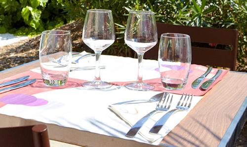 a table with four wine glasses and utensils on it at Campanile Lille - Lomme in Lomme